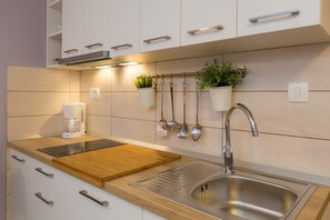 Mini-fridge, stovetop, dishwasher, espresso maker