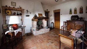 Un salon rustique avec une cheminée, des meubles en bois et un lustre.