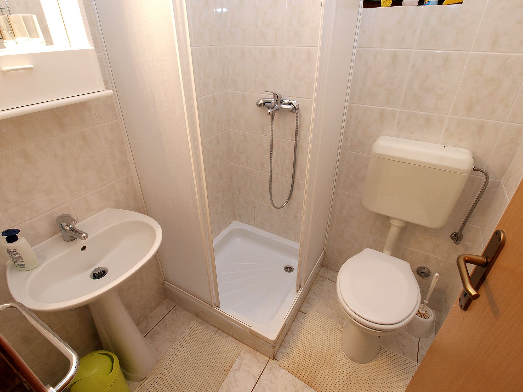 A bathroom with a sink, toilet, and shower.