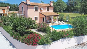 A two-story house with a swimming pool, surrounded by greenery and a clear sky. - Villa 377 (Tinjan)