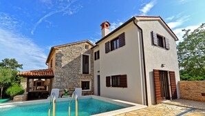A two-story house with a swimming pool, stone walls, and a tiled roof. - House 682 (Svetvincenat)