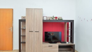 A modern entertainment unit with a TV, shelves, and a cabinet. - Apartment 725 (Fazana)