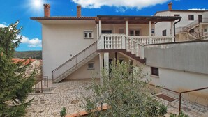 A two-story building with a stone staircase leading to a balcony. - Apartment 847 (Pula)
