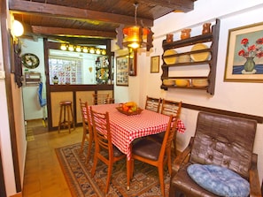 Enjoy meals in this inviting dining area with a table, comfortable seating, and a warm atmosphere.