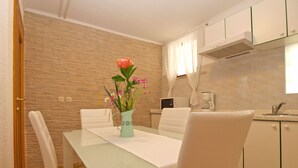 A modern kitchen with white cabinets, a microwave, and a coffee maker. - Apartment 959 (Vodnjan)