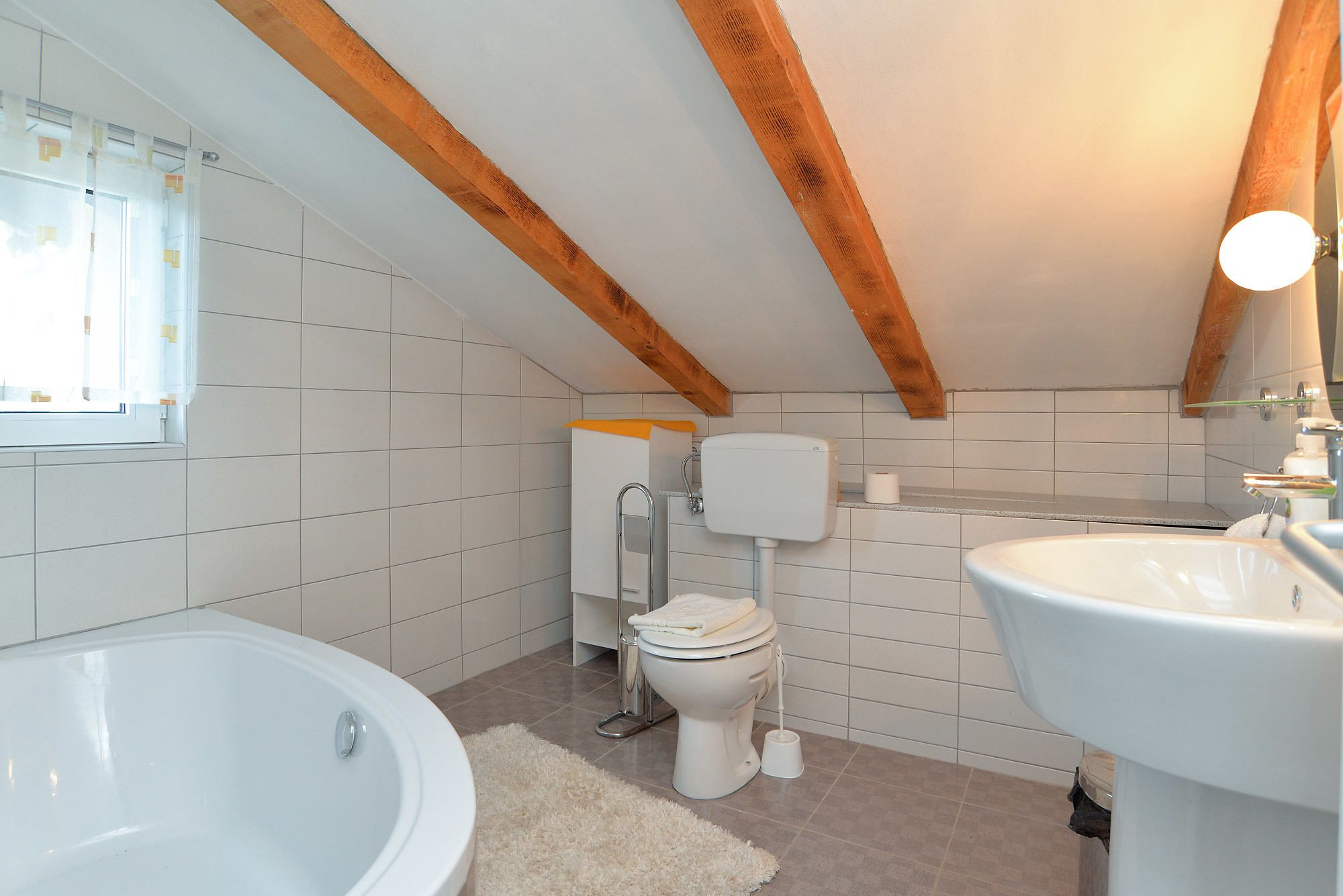 A bathroom with a bathtub, toilet, and sink.
