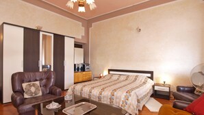 A well-lit bedroom with a bed, a sofa, a coffee table, and a dresser. - Apartment 1050 (Rovinj)