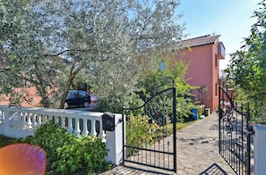 Stroll through the beautifully landscaped grounds to the entrance of this charming residence.