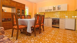 A dining area with a table set for four, surrounded by wooden chairs. - Apartment 1157 (Pula)