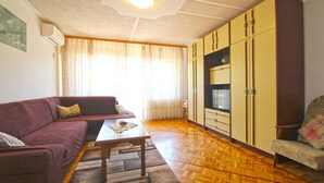 A living room with a sofa, a coffee table, a chair, and a wardrobe. - Apartment 1198 (Medulin)