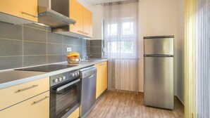Eine moderne Küche mit Herd, Backofen, Geschirrspüler und Kühlschrank.