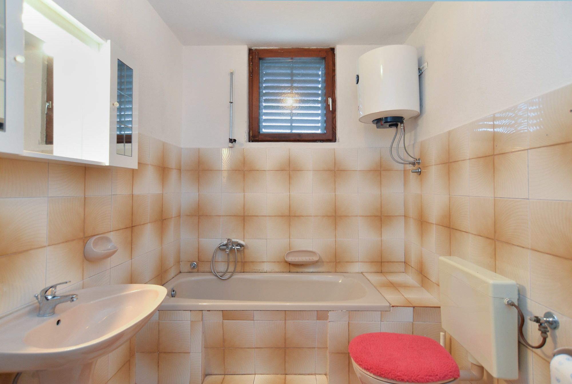A bathroom with a sink, bathtub, and toilet.