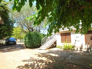Stroll up to this charming two-story home surrounded by lush greenery and a well-manicured hedge.