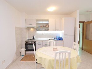 Enjoy meals at the dining table with chairs in this functional kitchen area.
