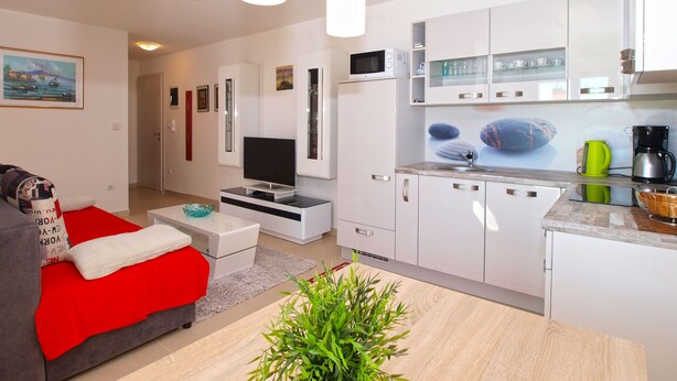 A modern apartment with a living room, kitchen, and dining area. - Apartment 1507 (Fazana)