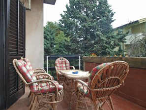 Enjoy dining or socializing in this cozy patio area with a round table and four comfortable chairs.
