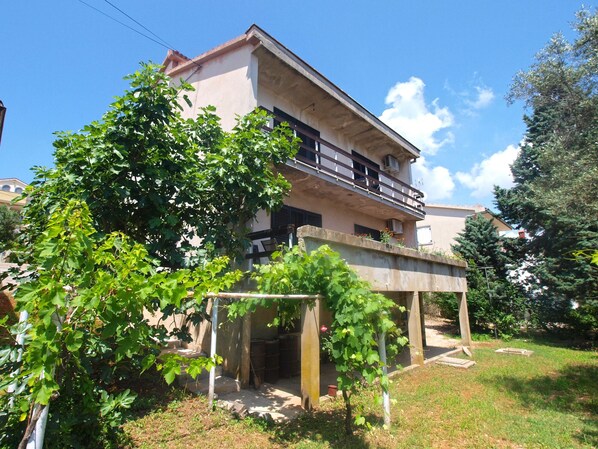 A two-story building with a balcony on the upper floor.