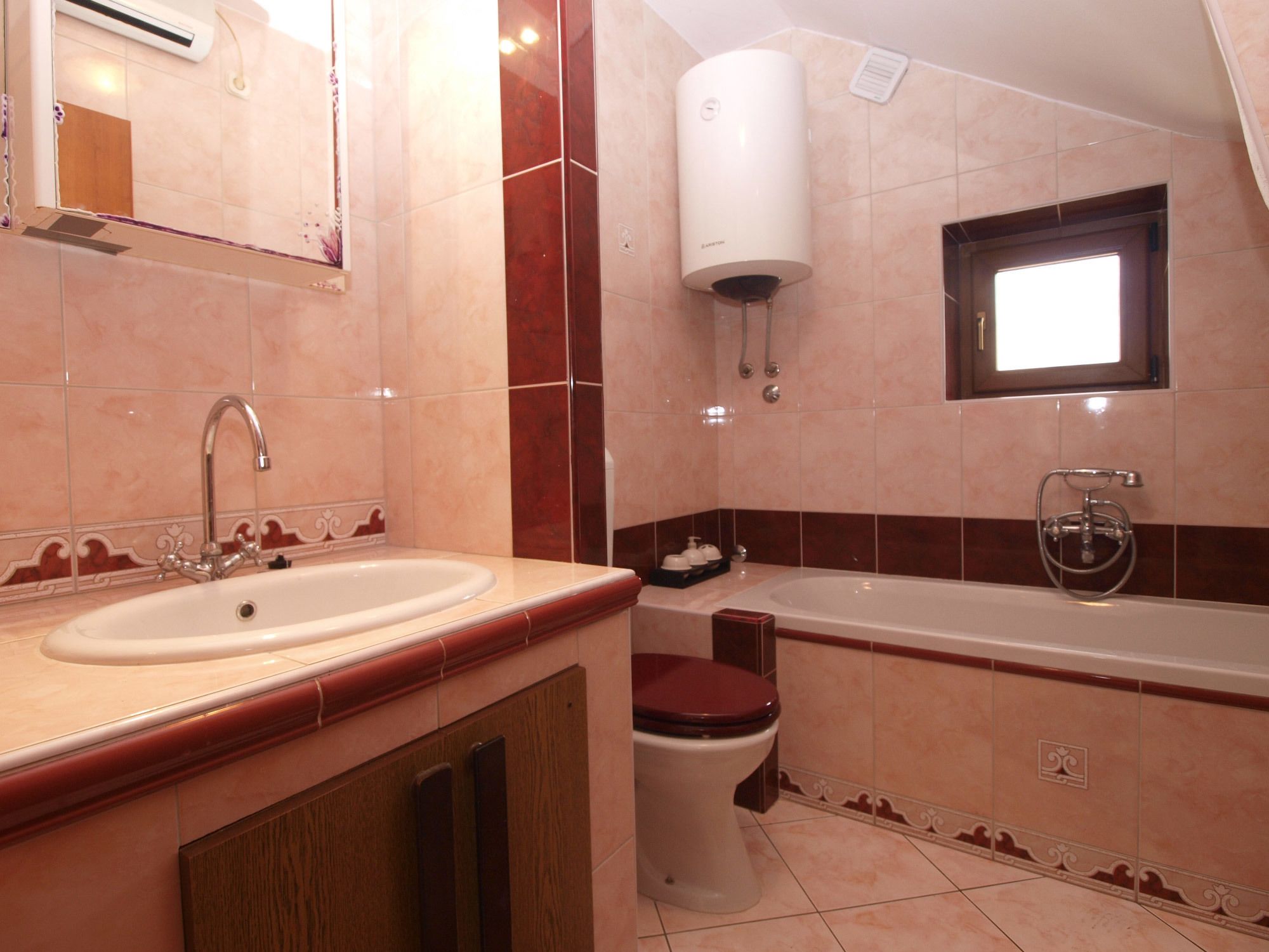 A bathroom with a sink, toilet, and bathtub.