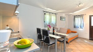 A compact living space with a kitchenette, dining area, and a sofa. - Apartment 1642 (Pula)