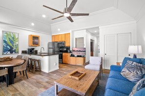 A modern living room with a dining area, kitchen, and a ceiling fan. - Rare find w/ 2 AC, 2 min walk to beach, Remodeled #151, ground floor!  (Koloa)