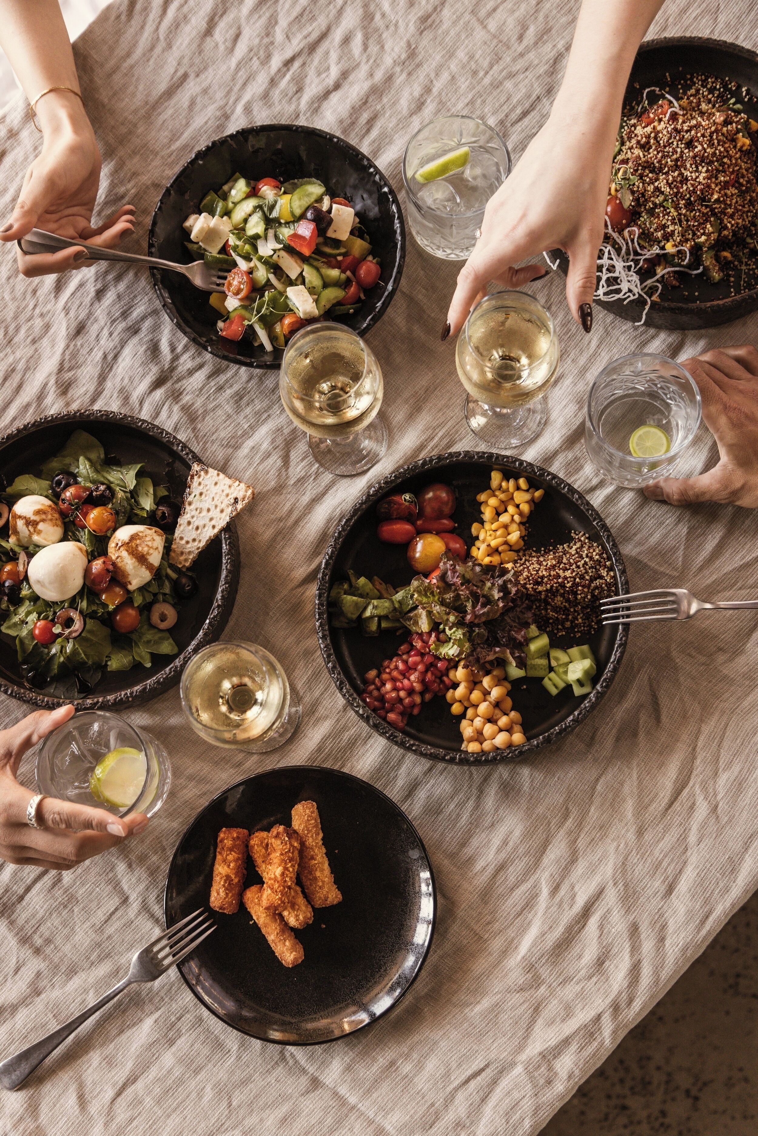 A table with various dishes and drinks, suggesting a dining setting.