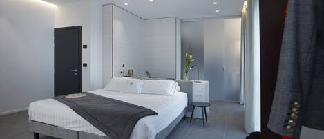 A modern bedroom with a bed, bedside table, and a wardrobe.
