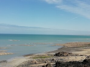 A coastal landscape with rocky terrain and calm waters.