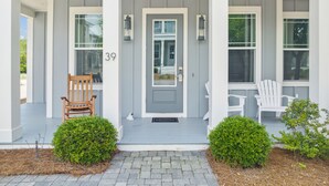 A house with a grey front door, two white chairs, and a number '39' on the wall. - Prime Location Near Community Pool | 6 Beach Bikes | Tram to Easy Beach Access (Santa Rosa Beach)