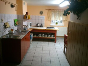 A compact kitchen with a sink, stove, and cabinets.