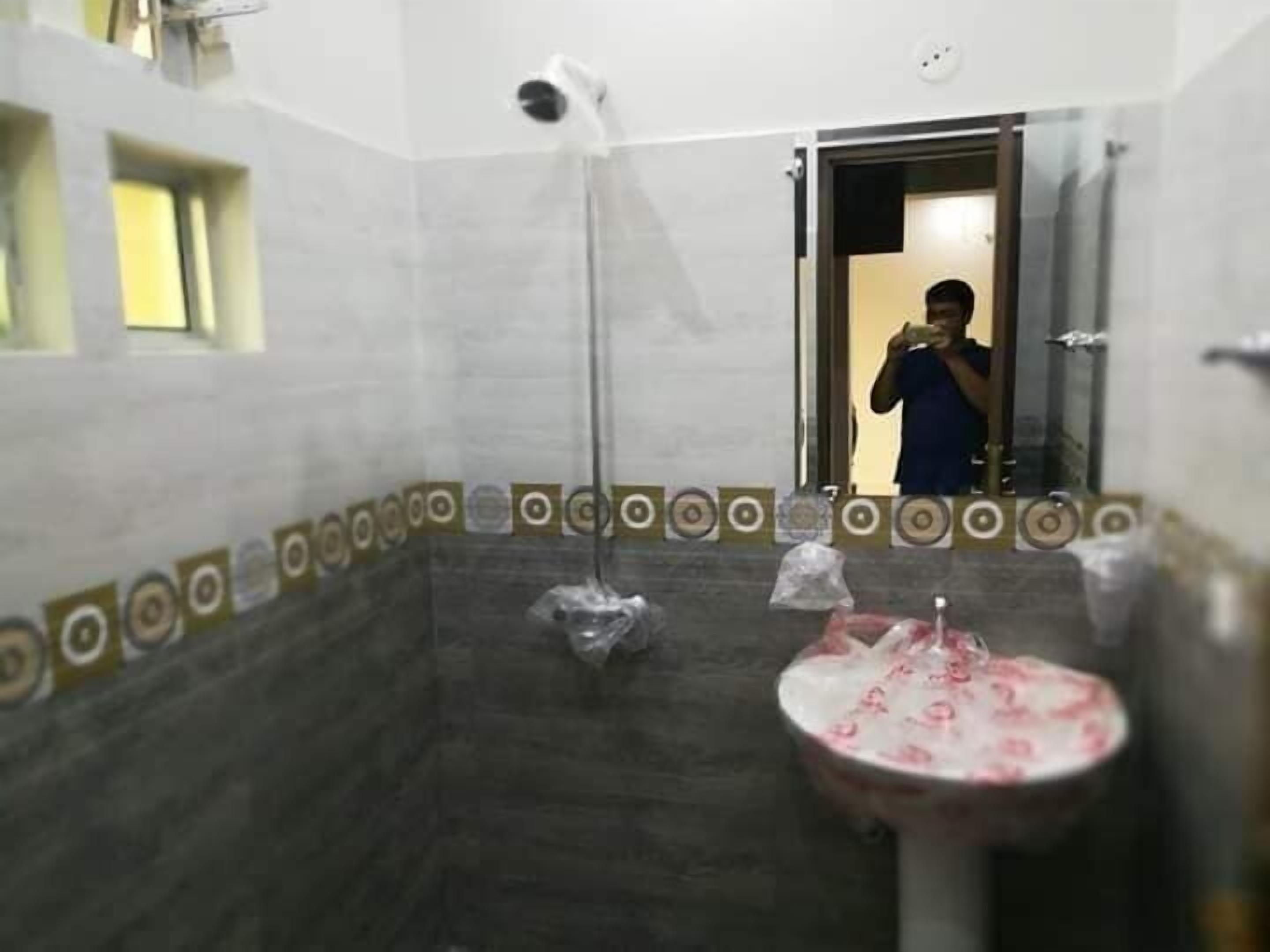 A bathroom with a shower, a sink, and a mirror.
