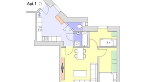 En plantegning af en flerrumslejlighed med køkken, spiseområde, to soveværelser og et badeværelse.