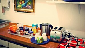 A kitchen counter with various food items, a toaster, and a painting on the wall. - Roman Place (Rome)