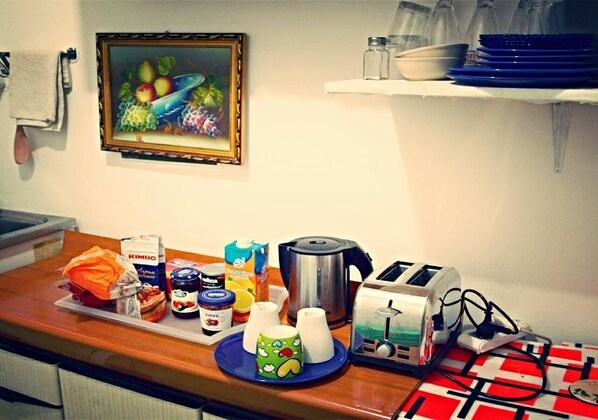 A kitchen counter with various food items, a toaster, and a painting on the wall.