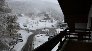 Ein verschneites Dorf mit Häusern und einer Straße.
