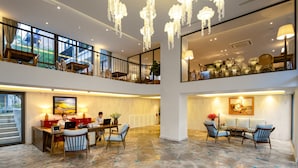 A spacious, multi-level interior with a dining area, a workspace, and a seating area with a view of the outdoors.