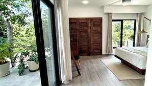 A modern bedroom with a large window, a bed, a chair, and a wooden wardrobe.