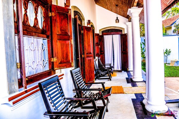 A corridor with wooden doors and benches.