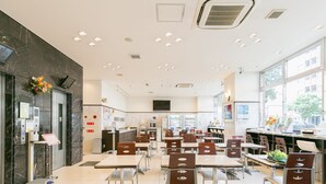 A modern restaurant with a clean, tiled floor and a mix of booth and table seating. - Toyoko Inn Akabane Station Higashi (Tokyo)