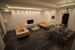 Superior Suite, 4 Bedrooms, Balcony | Living area | Flat-screen TV