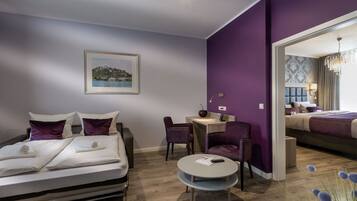 A modern hotel room with a bed, a desk, and a chair.