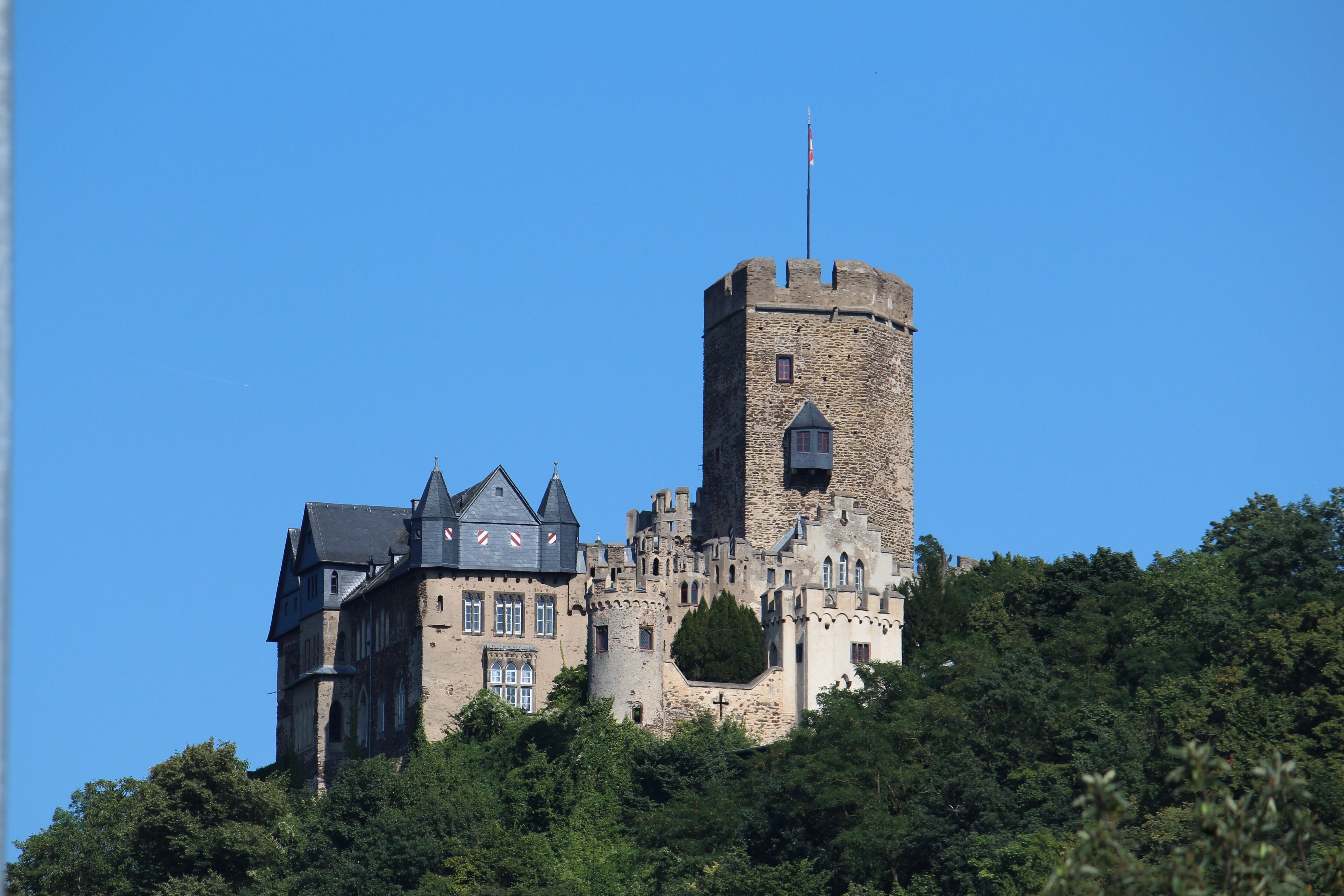 A castle with a prominent tower and a large building with multiple windows.