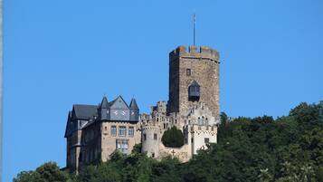 A castle with a prominent tower and a large building with multiple windows.