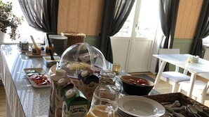 A breakfast buffet setup with various food items and beverages.