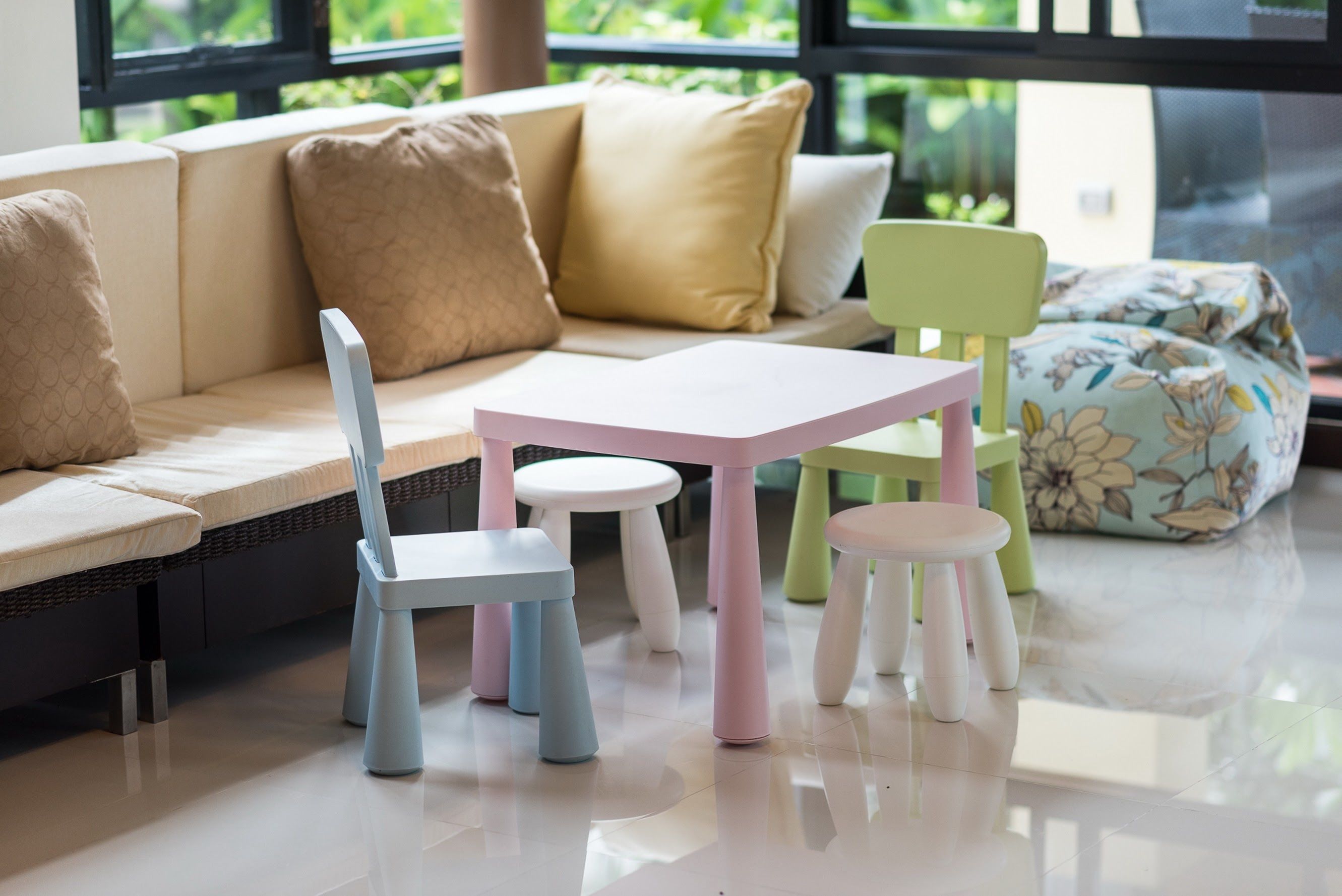 A modern living room with a sofa, a small table, and two chairs.