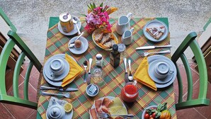 A table set for breakfast with plates, cutlery, a teapot, and a variety of food items. - Al Podere di Rosa (Lucca)