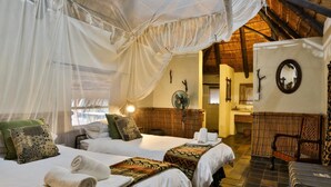 A room with two beds, a sitting area, and a bathroom. - Tangala Safari Camp (Hoedspruit)