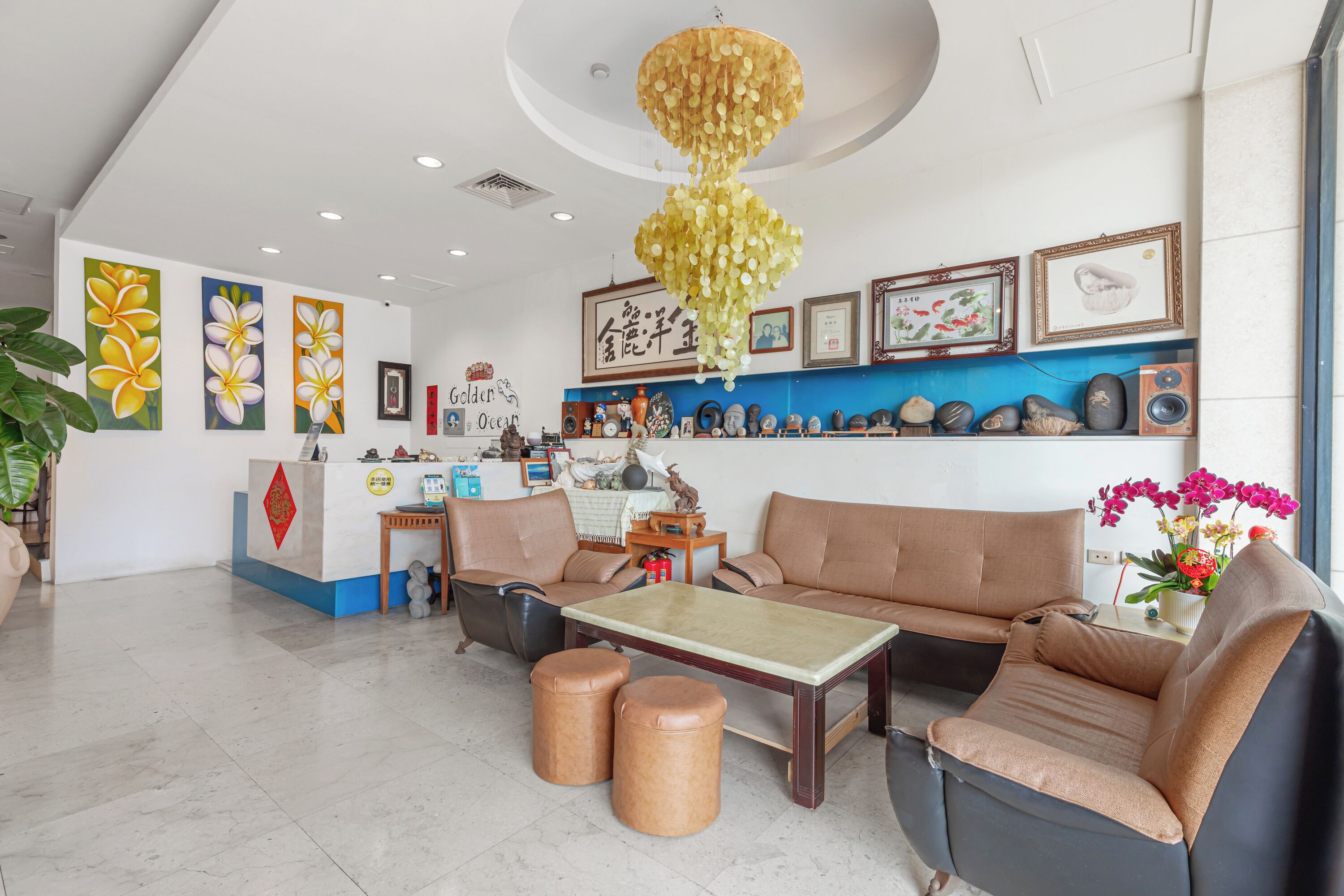 A reception area with a sofa, coffee table, and a desk with a computer.