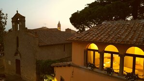 A historic building with a bell tower and a building with arched windows. - B&B A Piazza del Gesù (Viterbo)