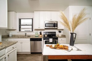 42-inch flat-screen TV with cable channels, TV, streaming services - Abode Nashville - Marathon Village Near Downtown (Nashville)