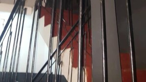 A staircase with metal railings and a handrail, leading to an upper floor. - Topway Hotel (Nkawkaw)